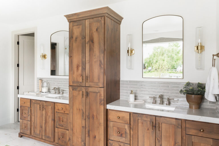 Utah custom bathroom vanity cabinets in stained wood with double sinks and quartz countertops.